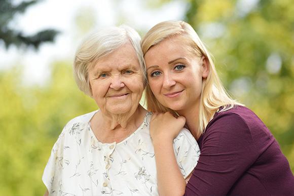 Home care in London. Domiciliary care services. Younique Care. Rehabilitation care. Young woman hugging elder