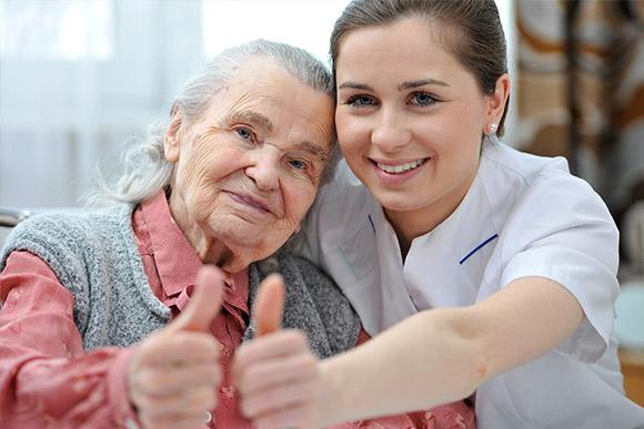 Home care in London. Domiciliary care services. Younique Care. Respite carer. Two thumbs up.