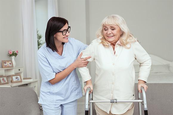 Home care in London. Domiciliary care services. Younique Care. Rehabilitation care. Woman using walker